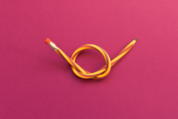 Flexible pencil . Isolated on purple background