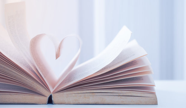 Old books take a paper page of it make heart shaped. Concept  gradually understand and learn to care for the heart.
