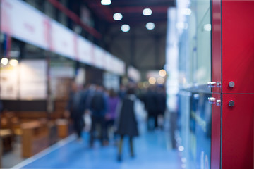 Business Convention Conference Blurred Defocused. Retail Sales Exhibition with People. Business Fair Expo Booth with People Shopping. Trade Show Building Interior Background with Exhibitors.