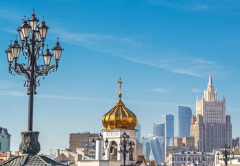 The diverse architecture of Moscow - houses, bell tower, skyscrapers, lanterns.