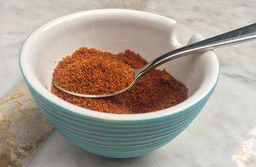 close up isolated still life of bowl full of refined gourmet brown sugar and teaspoon in natural organic and healthy nutrition concept