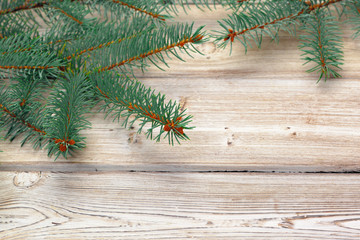 Christmas composition with fir tree branches on wooden background.