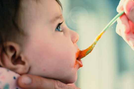 feeding a baby mush with a spoon