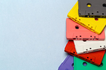 Bright retro cassette tapes on a light grey background