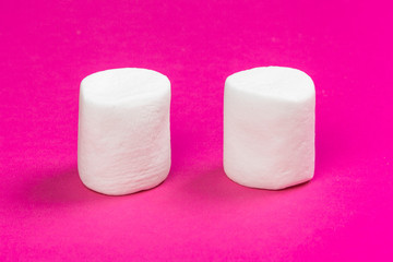 marshmallows on a pink background. top view