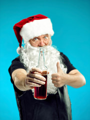 Portrait of Man in Santa Claus Costume - with a Luxurious White Beard, Santa's Hat and a Red Costume at red studio background with beer