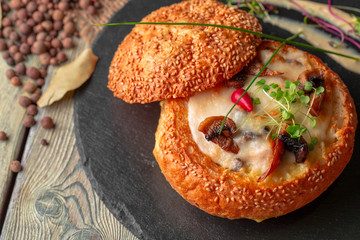 Homemade mushroom cream soup, served in bread bowl