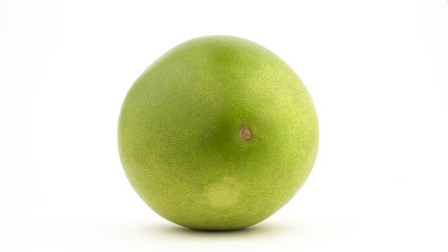 One whole big shaddock fruit. Lies on the side. Rotating. Isolated on the white background. Close-up. Macro.