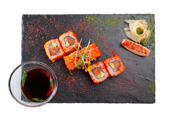 Black rectangle plate with sushi, isolated on white