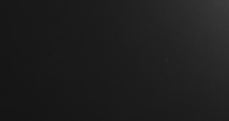 dust particles flow from bottom on black background