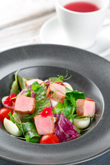 Green salad with cube slices of ham