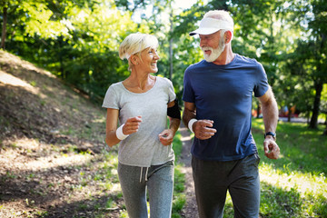 Mature couple jogging and running outdoors in city