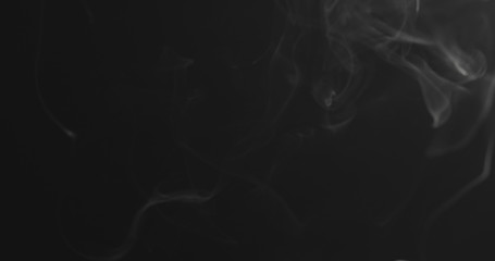 closeup vapor rises from bottom on black background
