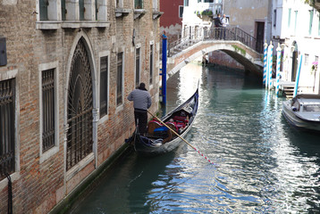 Fototapeta na wymiar Gondolier in canal in Venice 4366