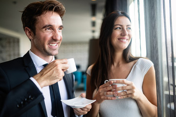 Young couple of professionals chatting during a coffee break