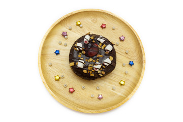 Donut chocolate on wood plate with star and pearl isolated on white background. Concept photo and clipping path for use.