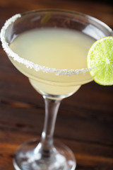 glass of delicious alcoholic cocktail on dark background