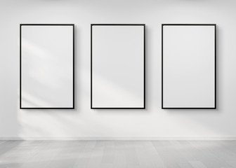 Three frames hanging on a wall mockup 3d rendering