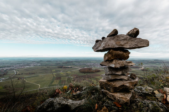 Closeup of a rock sculpture with a beautiful landscape of Ostalbkreis Germany in the backround