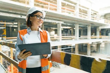 Portrait of mature architect woman at a construction site. Building, development, teamwork and...