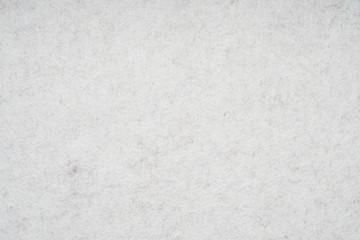 light gray or off-white felt background with fiber texture