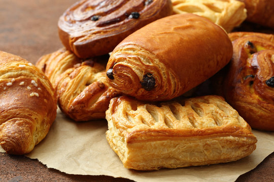 pasticceria dolci cornetti ciambelle e strudel su tavolo marrone