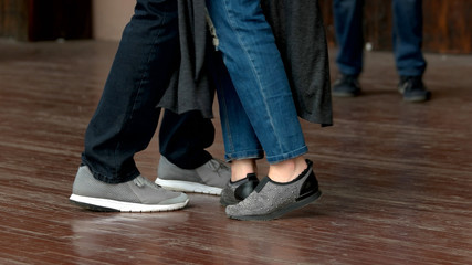 Feet of dancing couple. Foot of young man and woman dancing indoors.