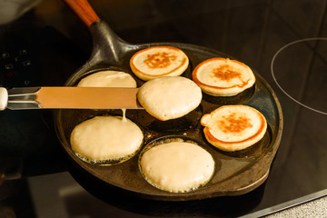 Turning pancakes in hot cast iron skillet.