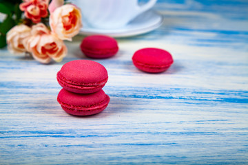 Berry macaroons, white cup and rose