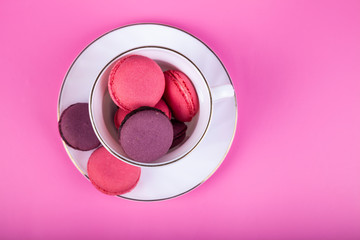 Berry macaroons in a white cup