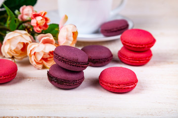 Berry macaroons. white cup and rose