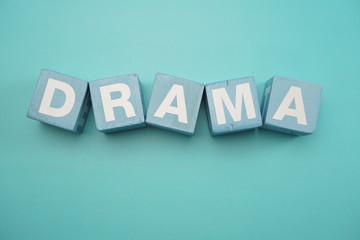 Obraz premium Drama word created with cubes alphabet letters on blue background