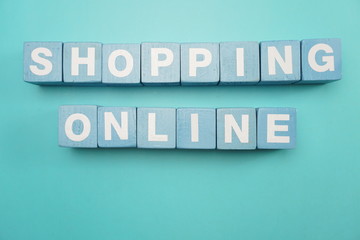 Shopping Online word alphabet letters flat lay on blue background