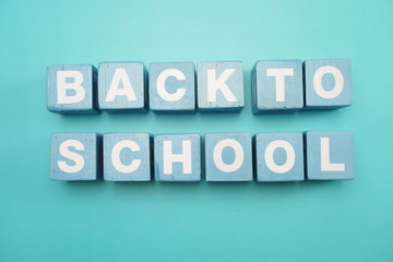 Back to School text alphabet letters top view flat lay on blue background