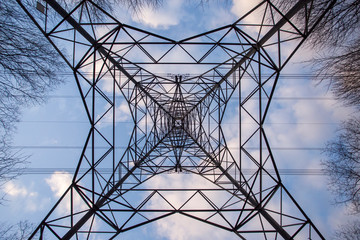 high voltage pylon against blue sky