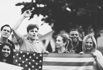 Group of activists showing American flag and blank posters