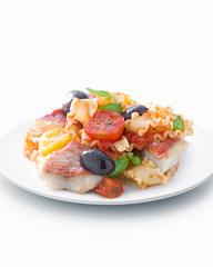 Grilled fish with vegetables on white plated, close-up