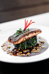 salmon fillet with steamed spinach and corn with soy sauce