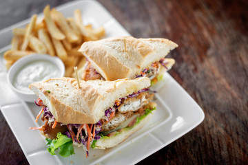 fried battered fish fillet sandwich with fries and tartar sauce