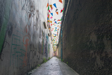 A narrow alley and Colorful flag.