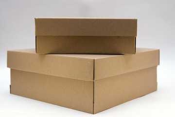 two cardboard boxes lie one on the other on a white background