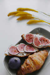 Closeup of croissant with fig - obrazy, fototapety, plakaty