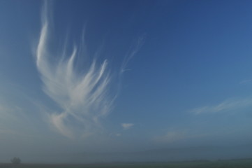 Sky. Dawn, sunrise. Clouds over the meadow.