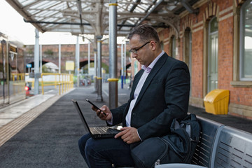 young businessman seating at the train station