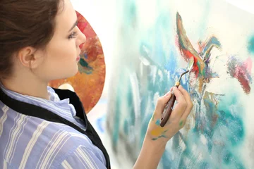 Foto auf Acrylglas Female artist painting picture in workshop © Pixel-Shot