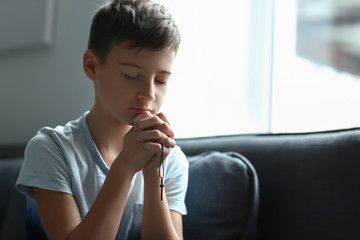 Fototapeta na wymiar Little boy praying at home