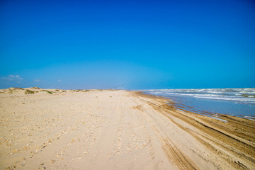 Fototapeta na wymiar A beautiful soft and fine sandy beach along the gulf coast of Texas in South Padre Island, Texas