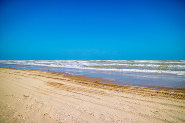 A beautiful soft and fine sandy beach along the gulf coast of Texas in South Padre Island, Texas