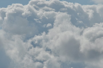 Fototapeta na wymiar Puffy clouds against a blue sky. Beautiful, sunny weather.