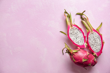 Tasty dragon fruits on color background